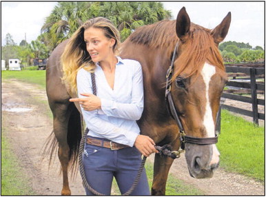 Jasmin von Oertzen and her horse, Pop, experience techniques of The Healing Touch for Animals practiced by Chris Wheeler of Pawsitive Animal Wellness in Venice. Wheeler is helping the horse overcome a neurological condition contracted by eating or drinking contaminated food or water. PHOTO BY PAM JOHNSON